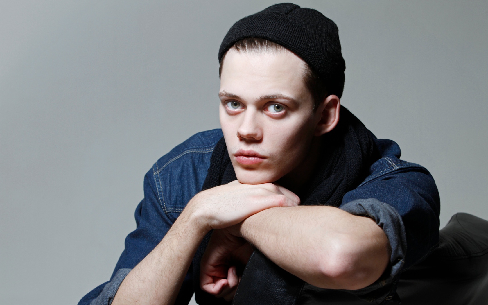 Молодой актер Билл Скарсгорд в черной шапке