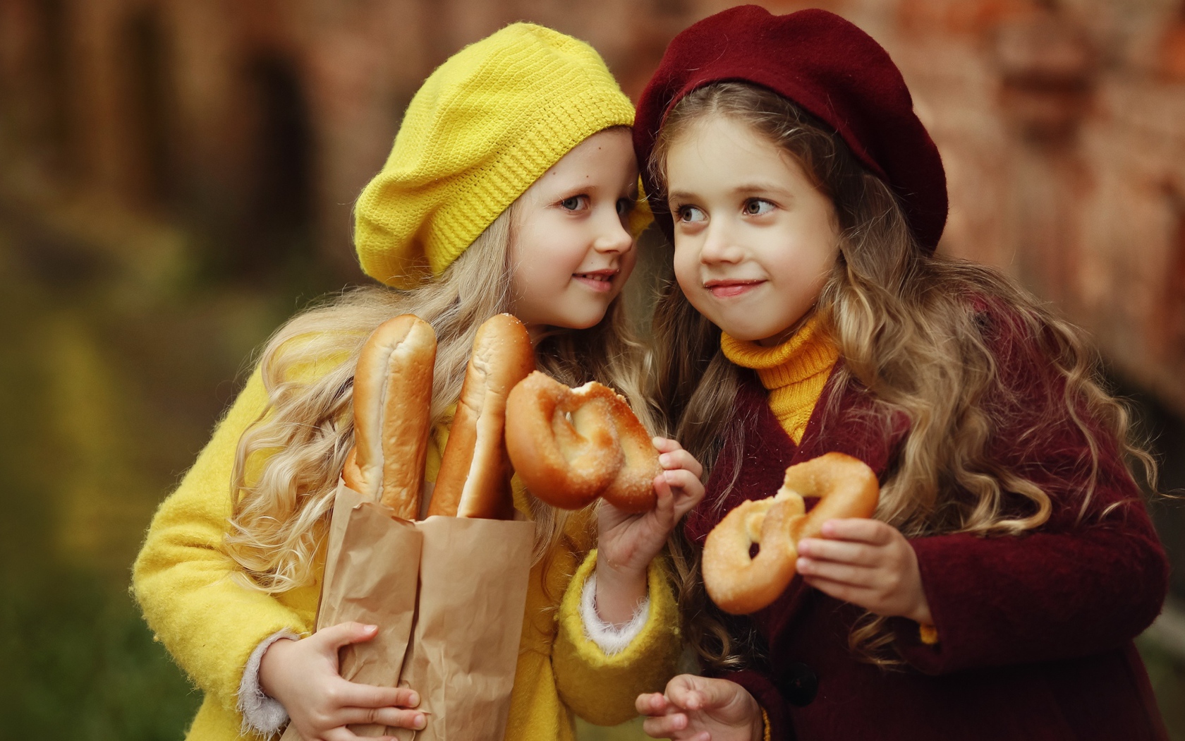 Две маленькие девочки с булочками 