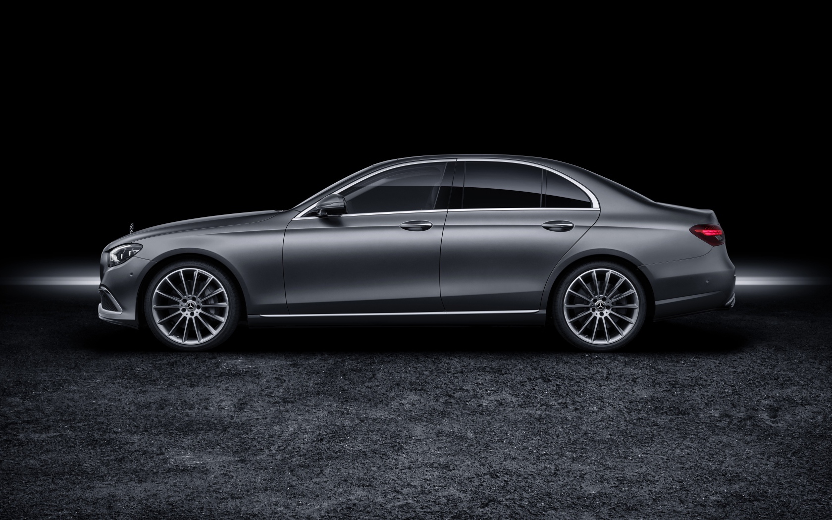 Серебристый автомобиль Mercedes-Benz E-Klasse 2020 года на черном фоне