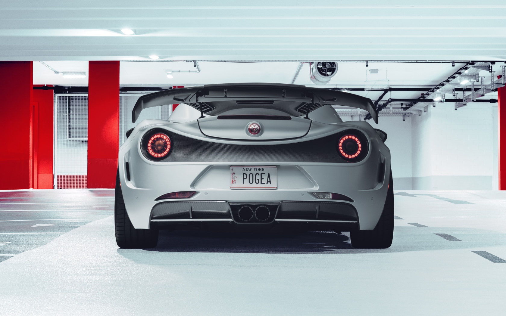 Серый автомобиль Pogea Racing Nemesis 2020 года вид сзади