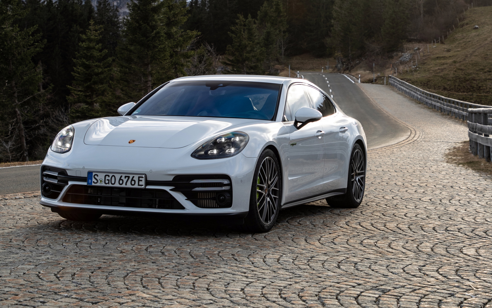Белый автомобиль Porsche Panamera Turbo S E-Hybrid 2021 года на дороге