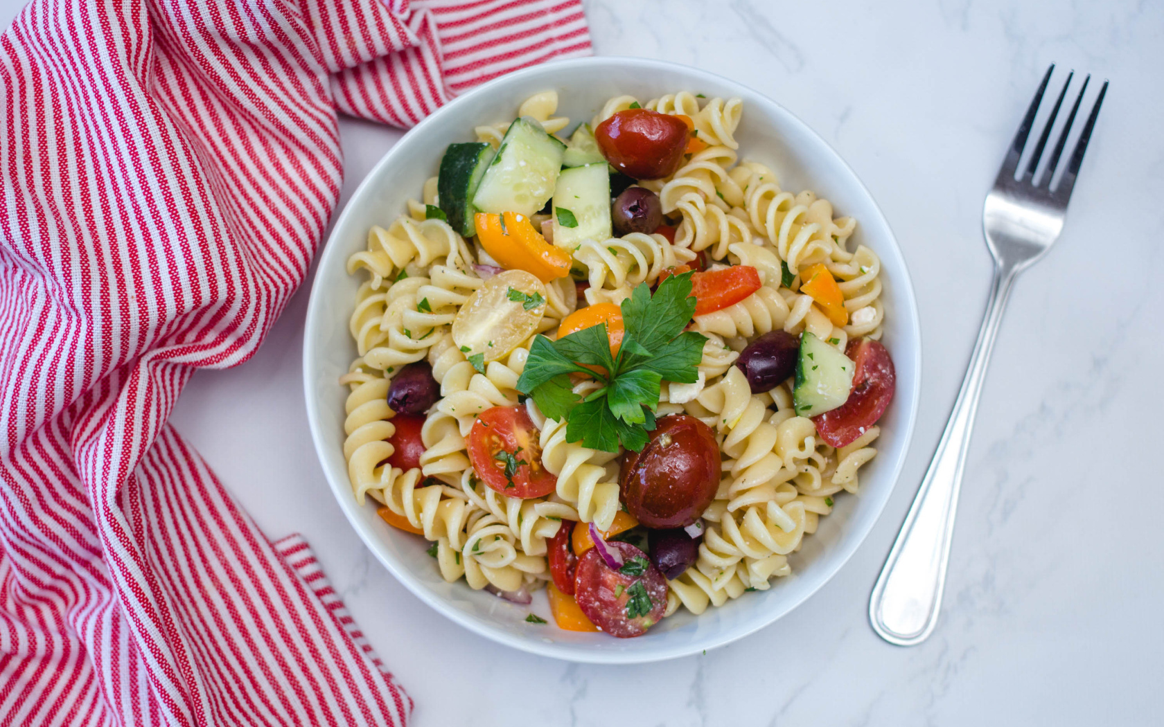 Макароны в тарелке с овощами на столе 