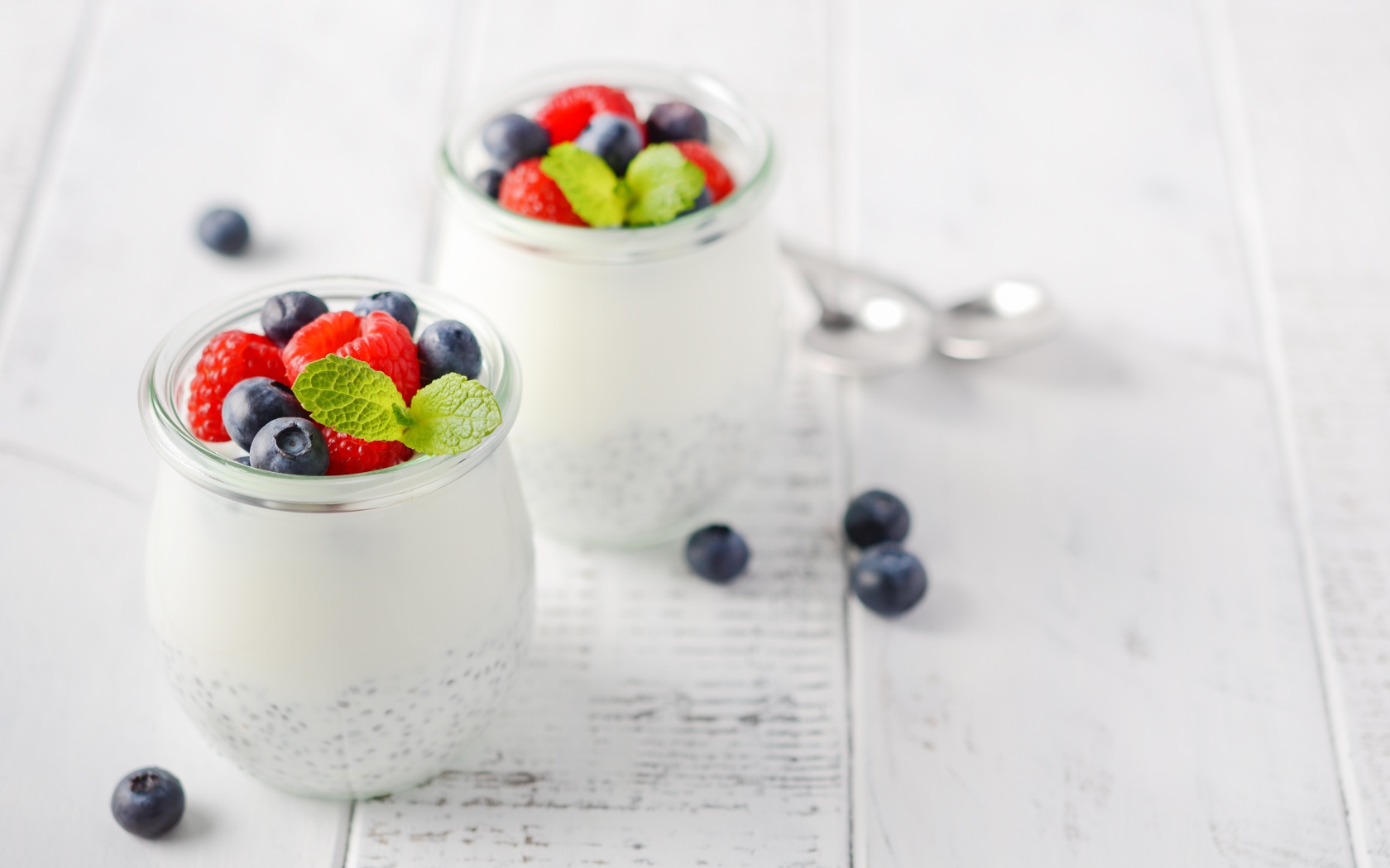 Йогурт в баночке с семенами годжи и ягодами черники и малины