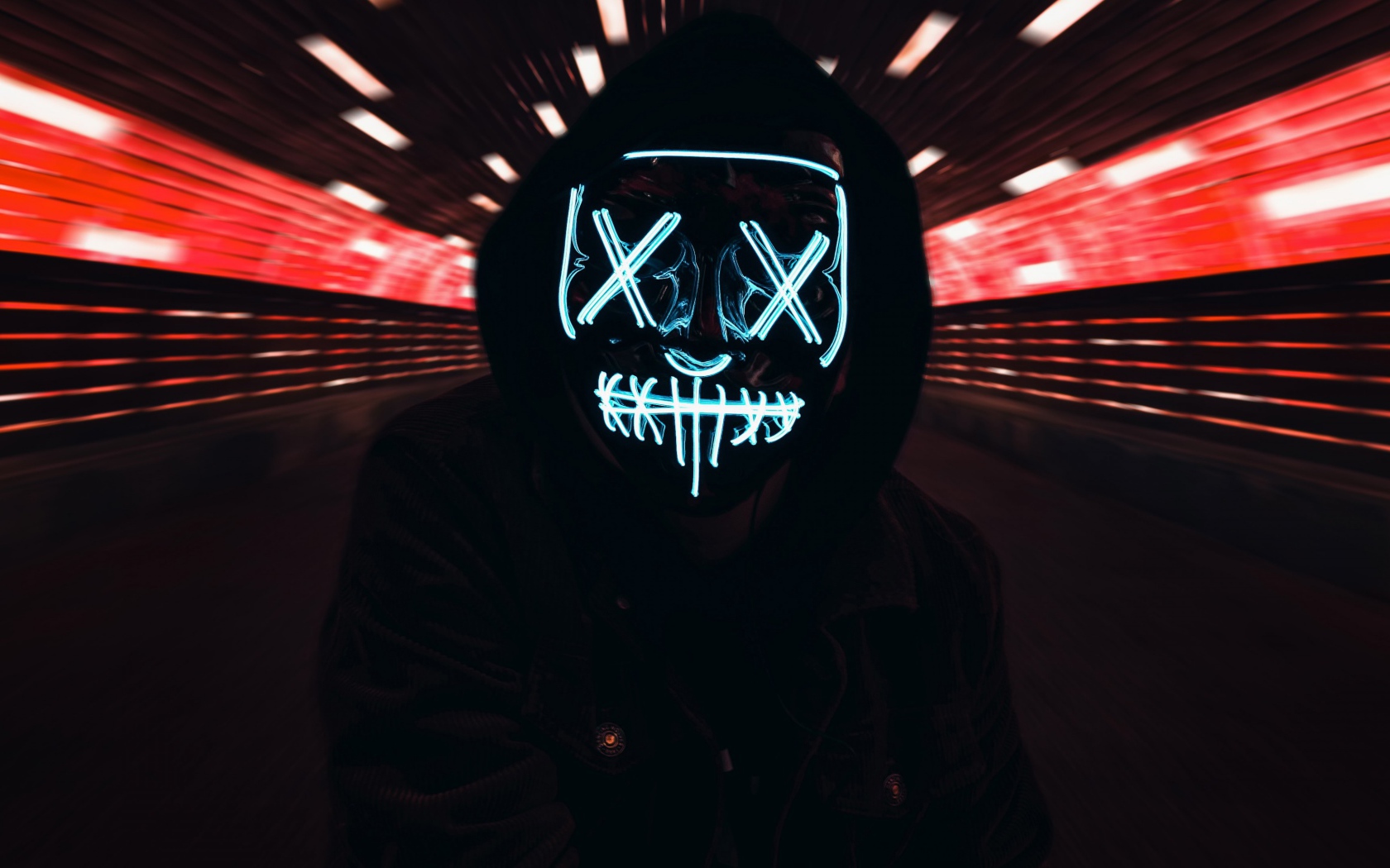 The guy in the black jacket in the neon mask of anonymous on his face