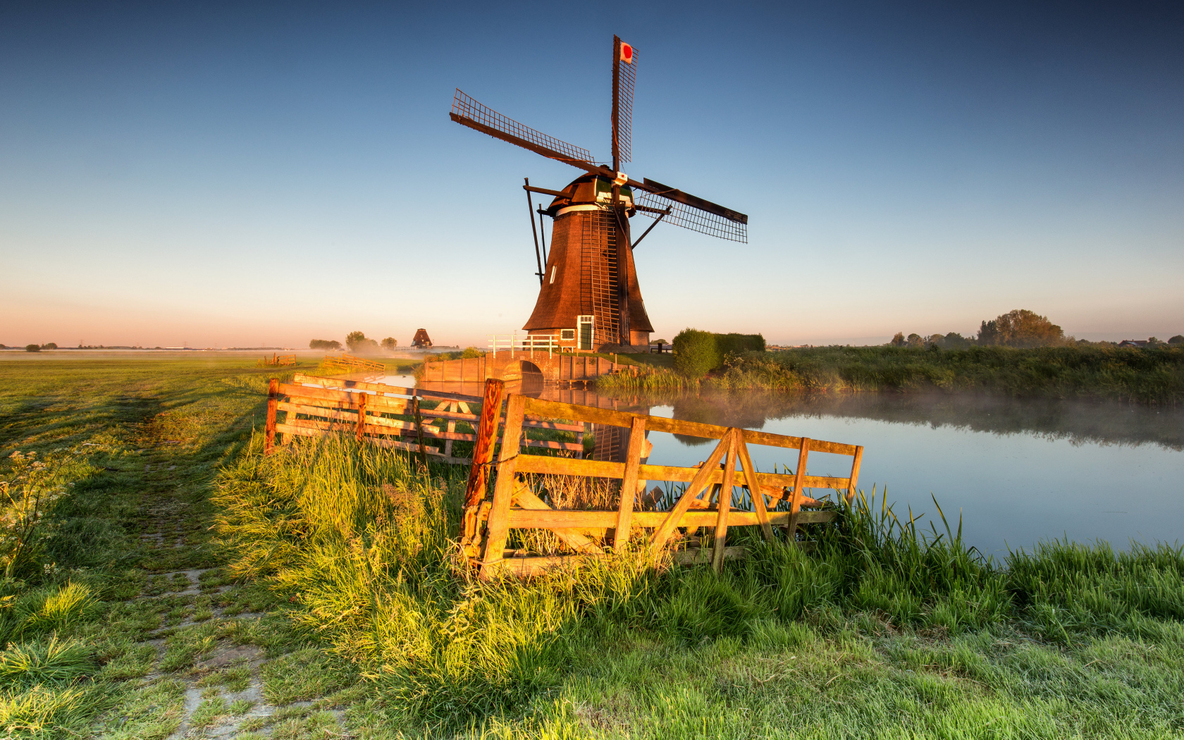 Старая мельница на берегу озера на ферме 