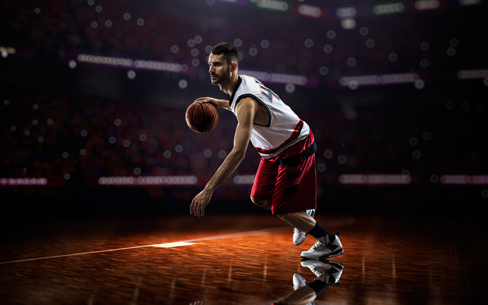 Мужчина баскетболист отбивает мяч на поле 