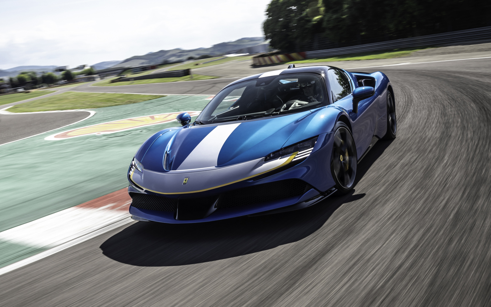 Гоночный автомобиль Ferrari SF90 Stradale Assetto Fiorano 2021 года на трассе