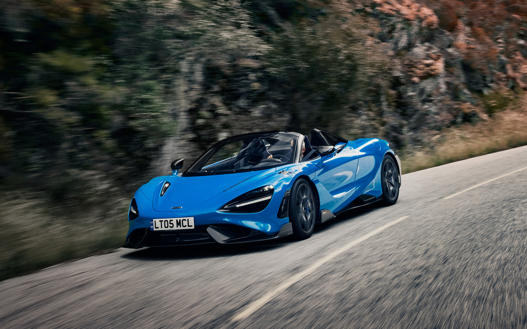 Синий кабриолет McLaren 765LT Spider 2022 года на дороге 