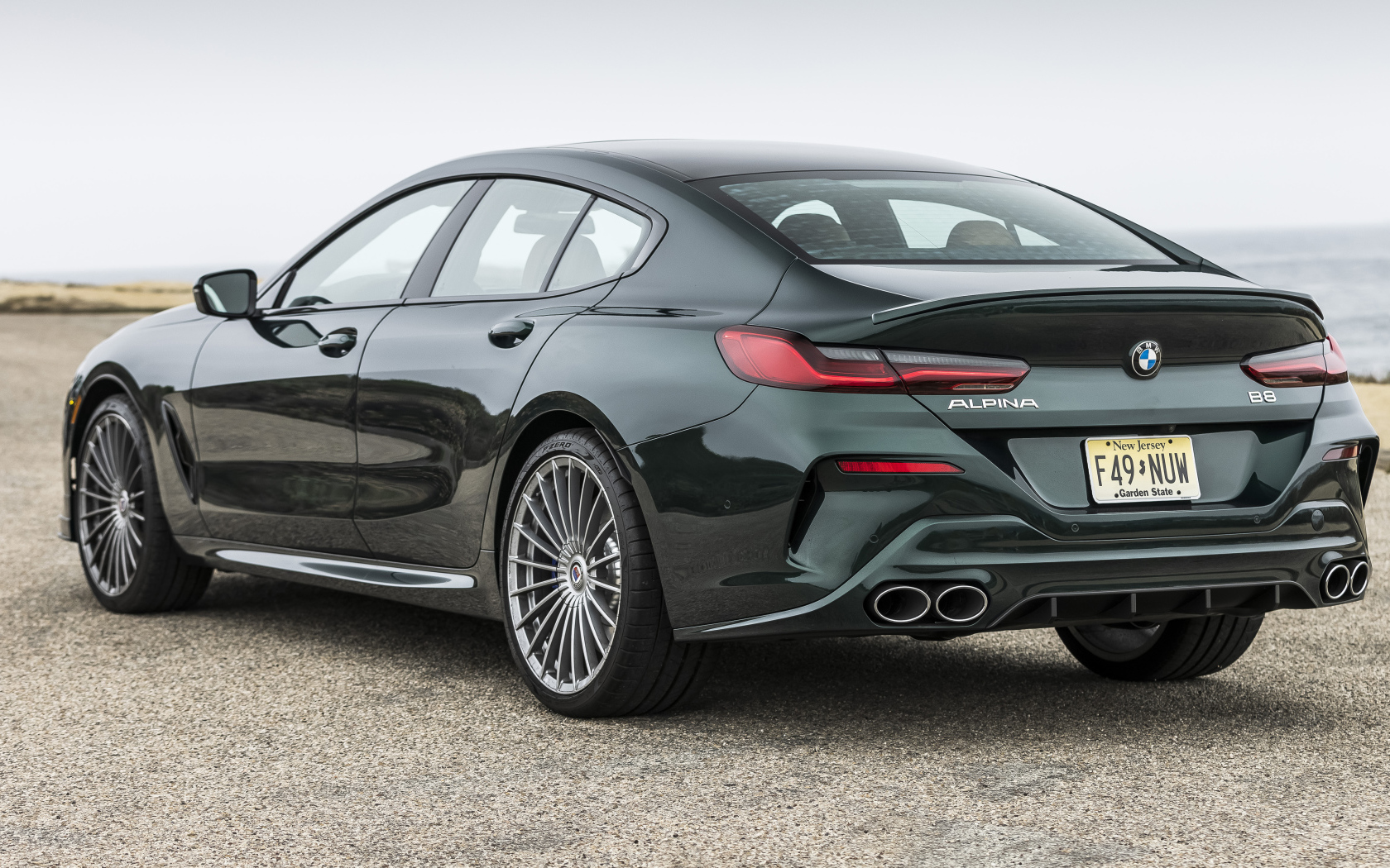 Черный автомобиль Alpina B8 Gran Coupé, 2022 года вид сзади