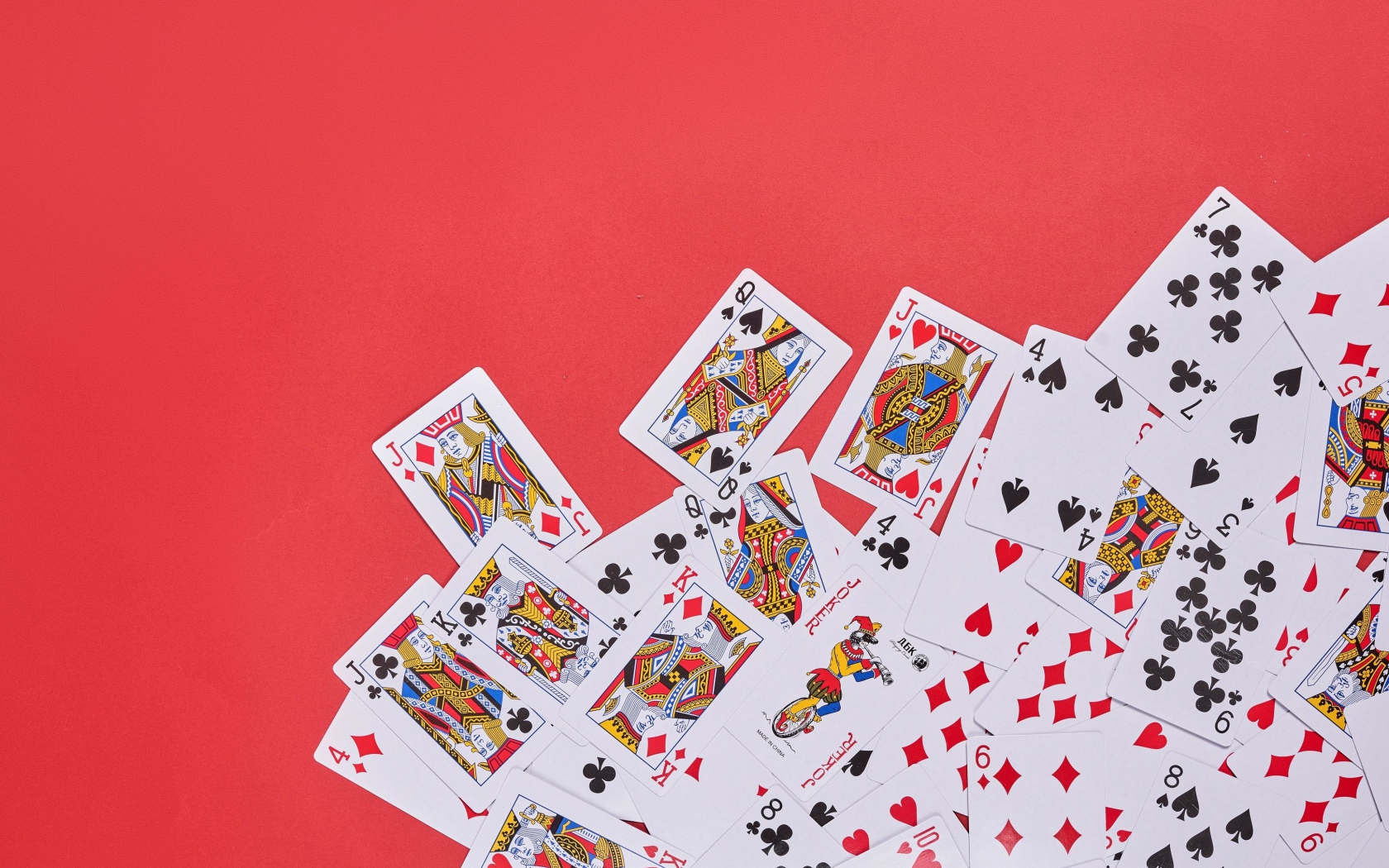 Deck of playing cards on red background