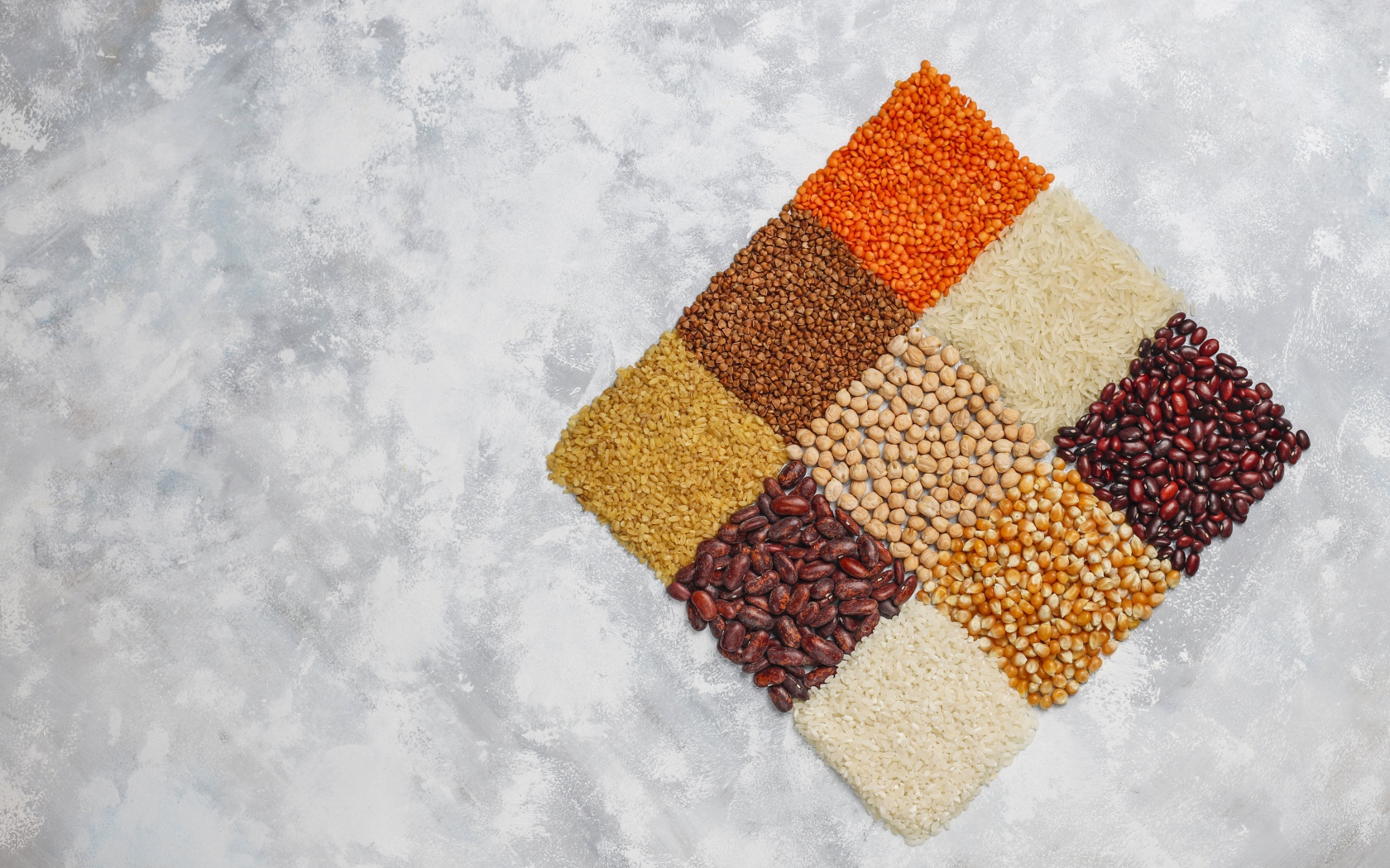 Ромб из разных видов крупы на сером фоне 