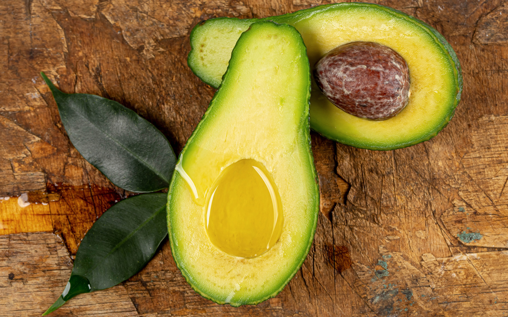 Зеленое авокадо на деревянном столе