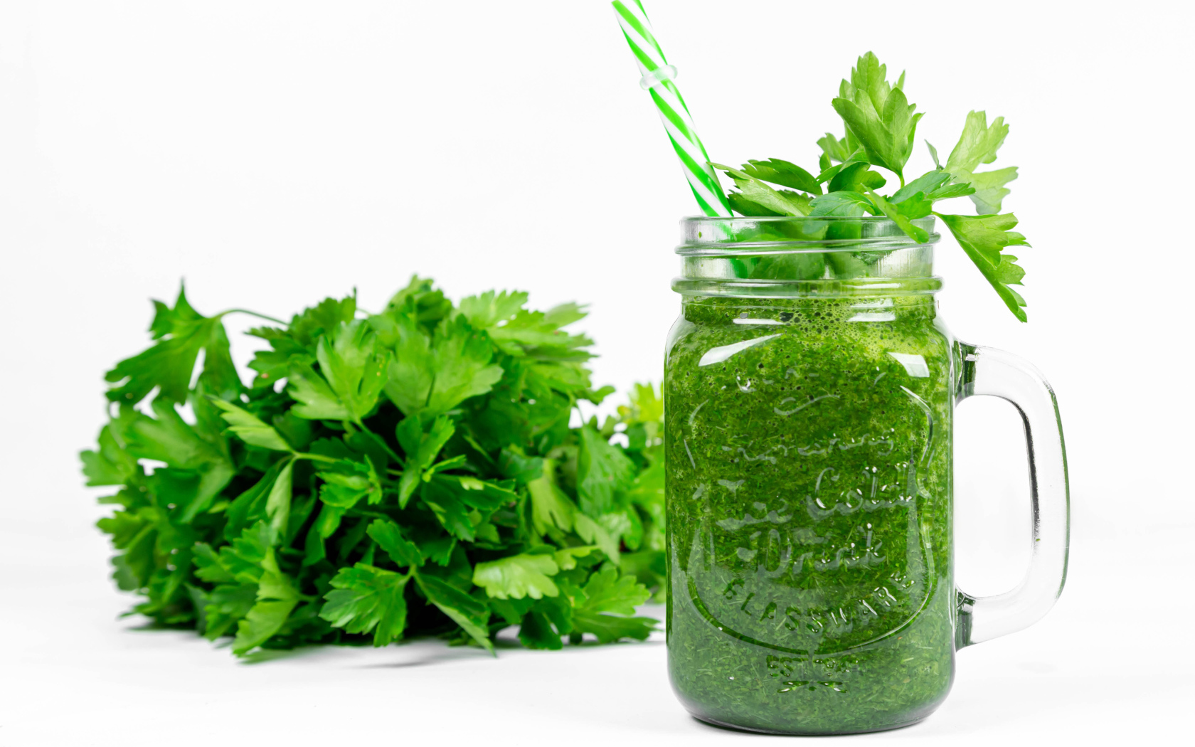 Green smoothie on the table with parsley