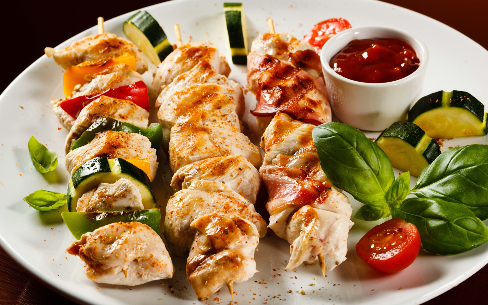 Appetizing chicken kebab with zucchini on a plate