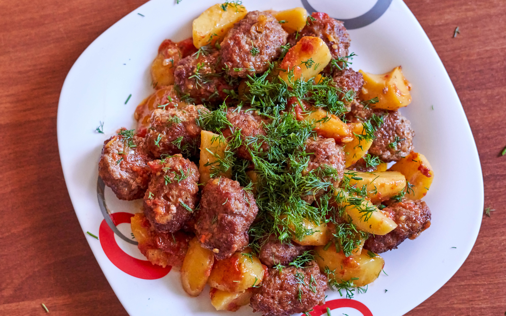 Фрикадельки с картофелем и укропом на белой тарелке