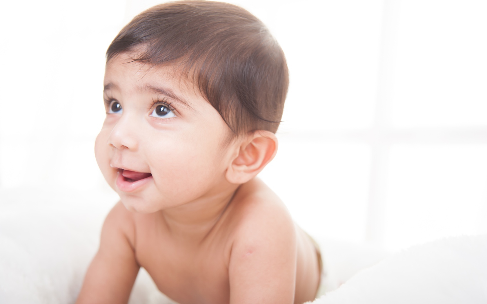 Маленький кареглазый мальчик на белом фоне 