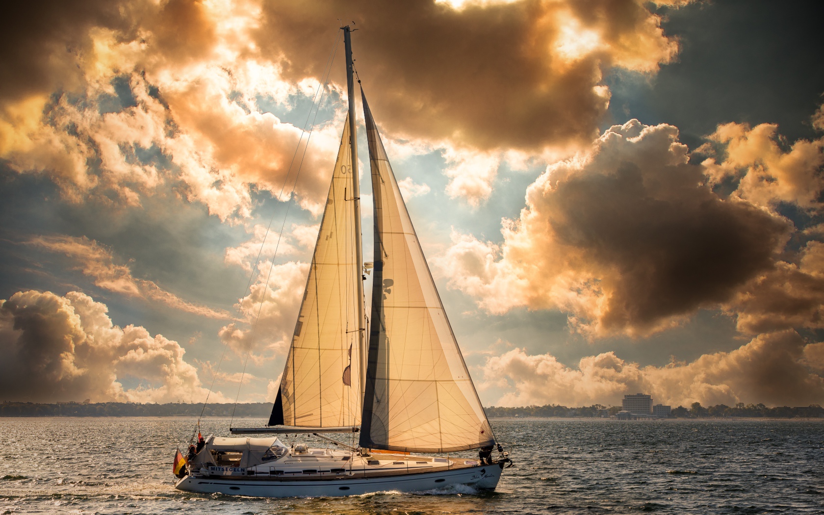 Большая парусная яхта в море на закате 