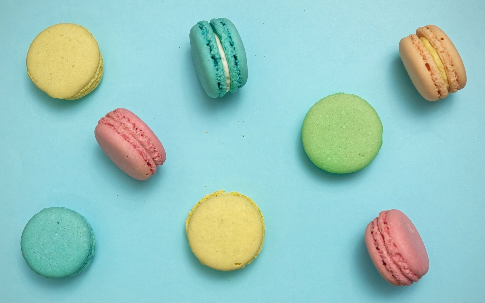Разноцветный десерт макарон на голубом фоне
