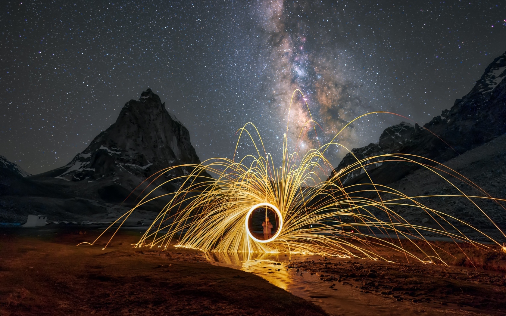 Огненное шоу под ночным красивым небом в горах