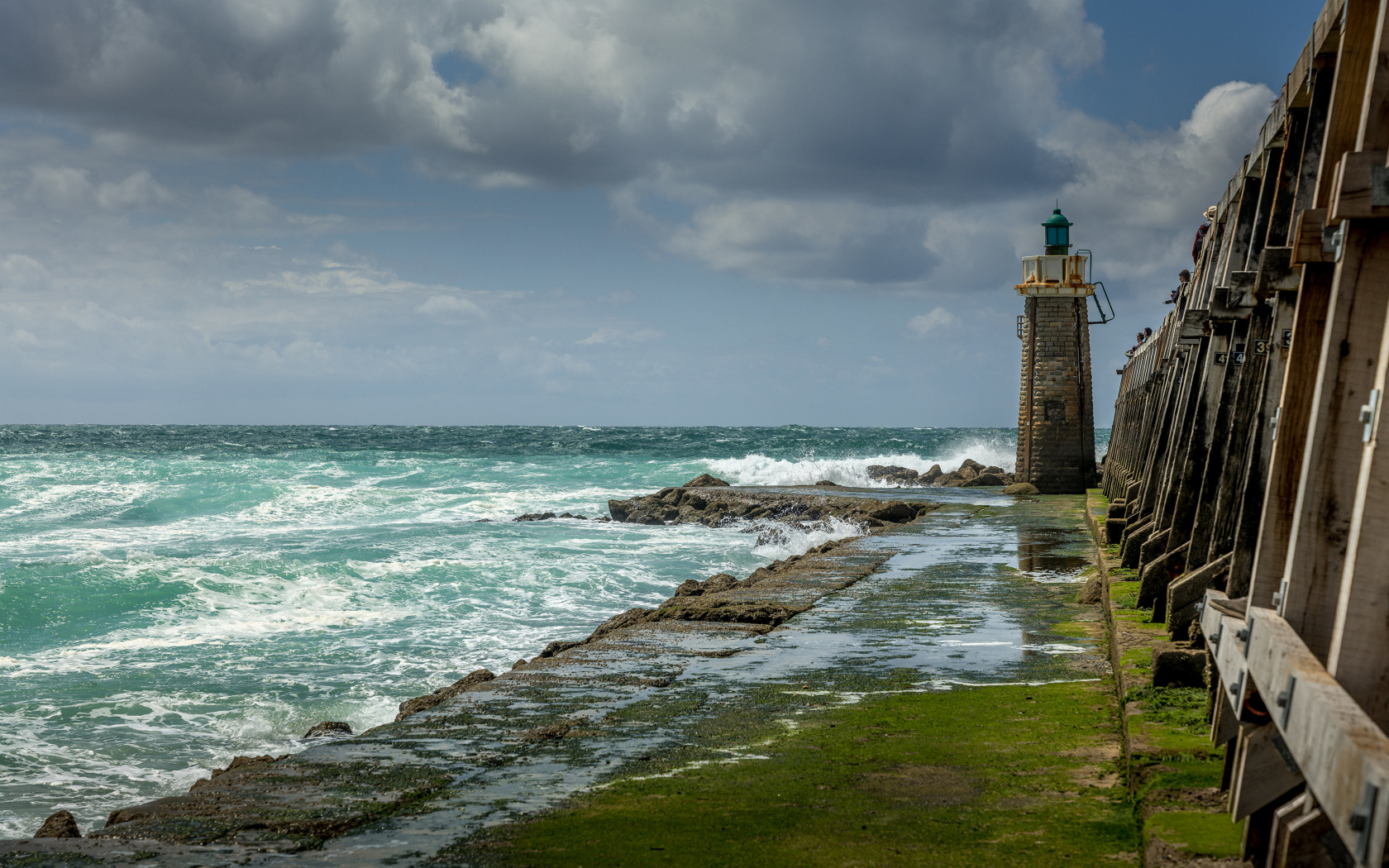 Lighthouse on the shore of the raging sea