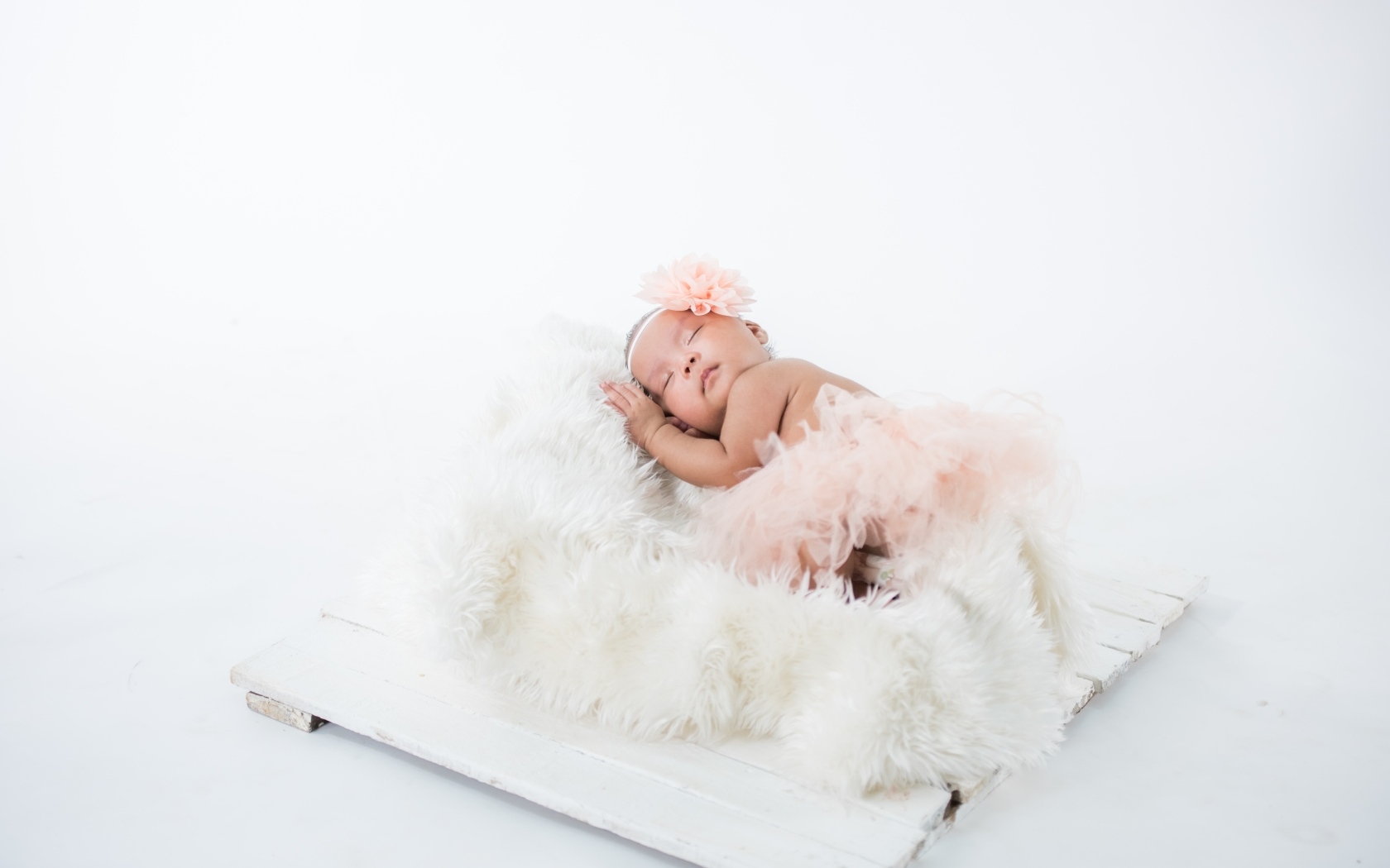 Милая спящая девочка в розовой юбке 