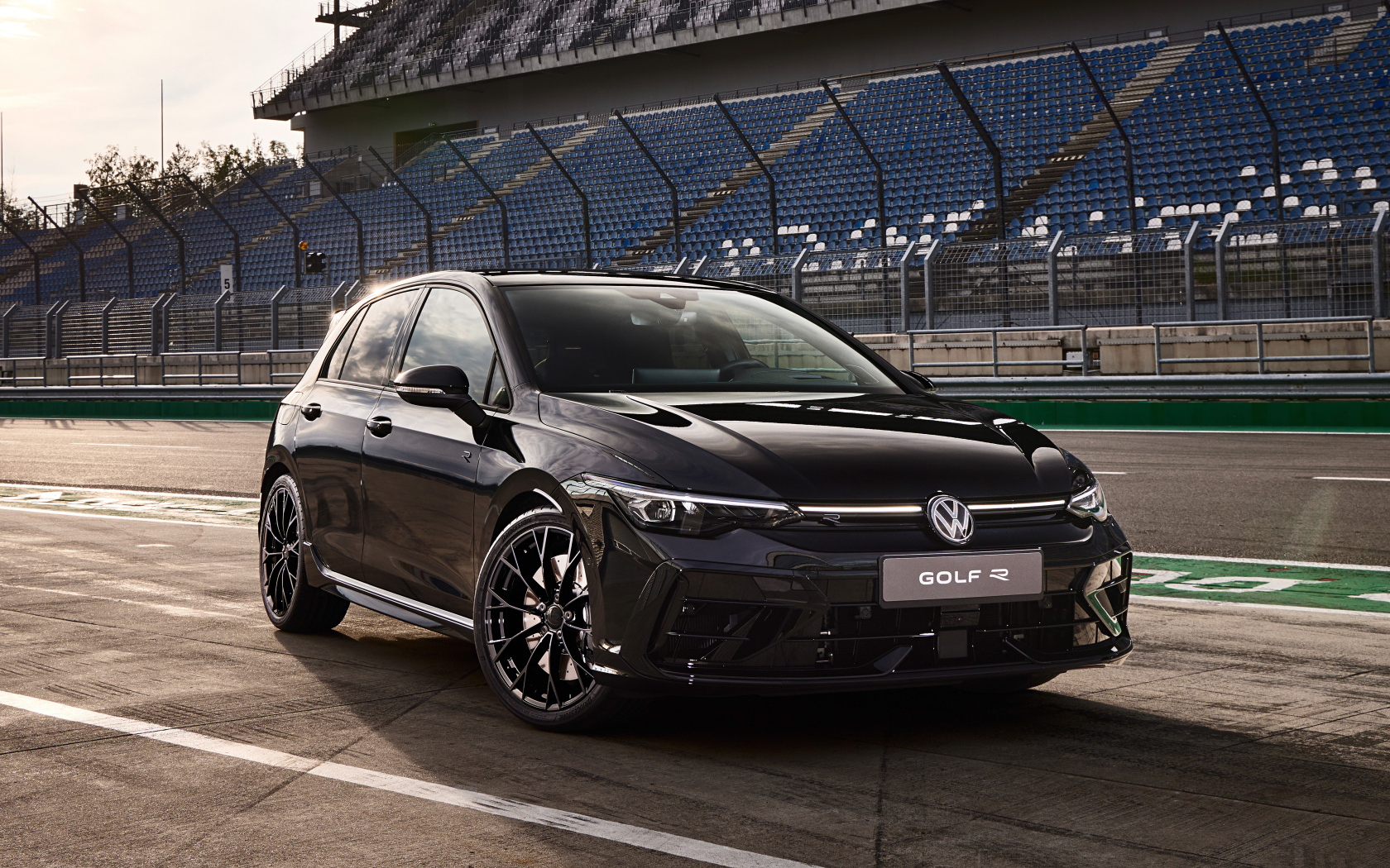 Черный Volkswagen Golf R Black Edition Worldwide 2024 года на стадионе