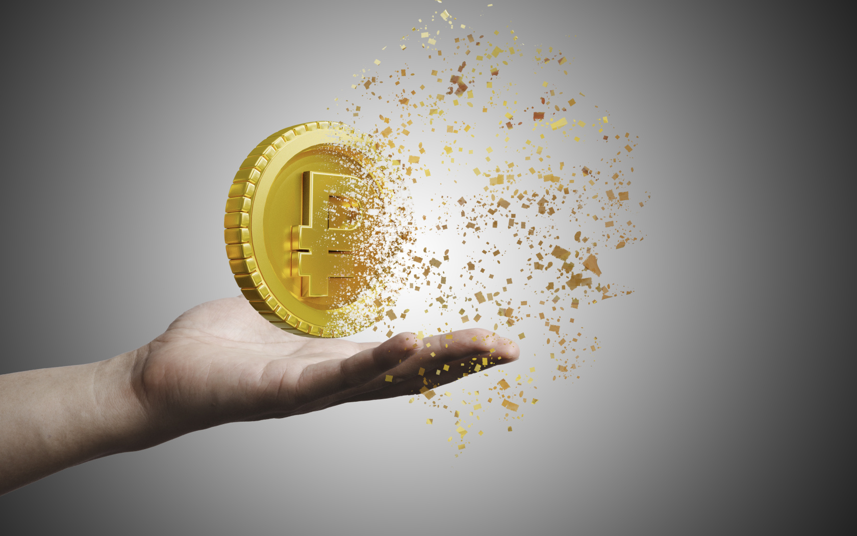 Монета разрушается на ладони на сером фоне