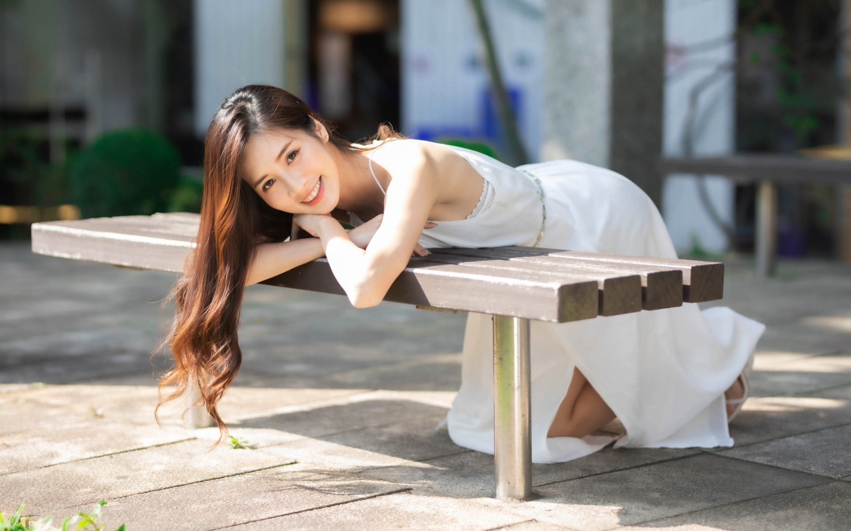 Девушка азиатка в белом платье с милой улыбкой