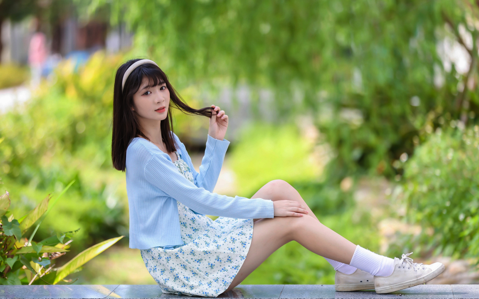 Милая азиатка в голубой кофте и в платье