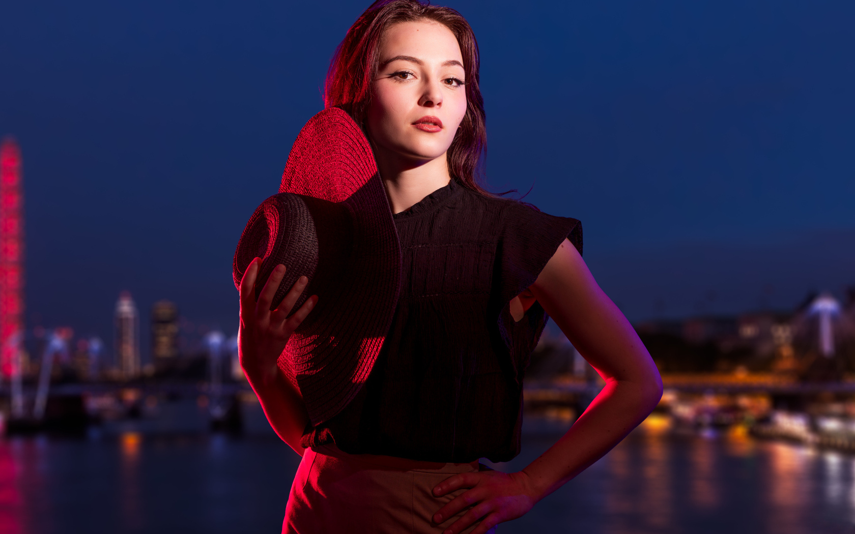 Девушка в лучах света со шляпой в руках