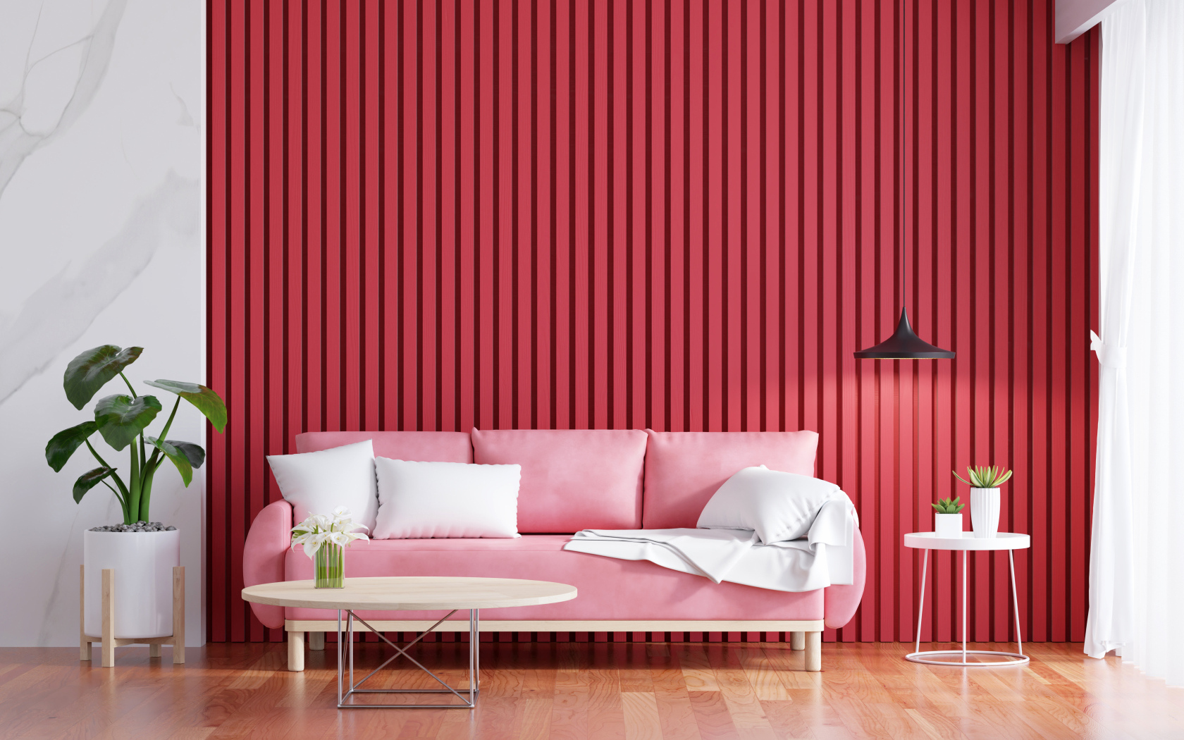 Розовый диван на фоне красной стены
