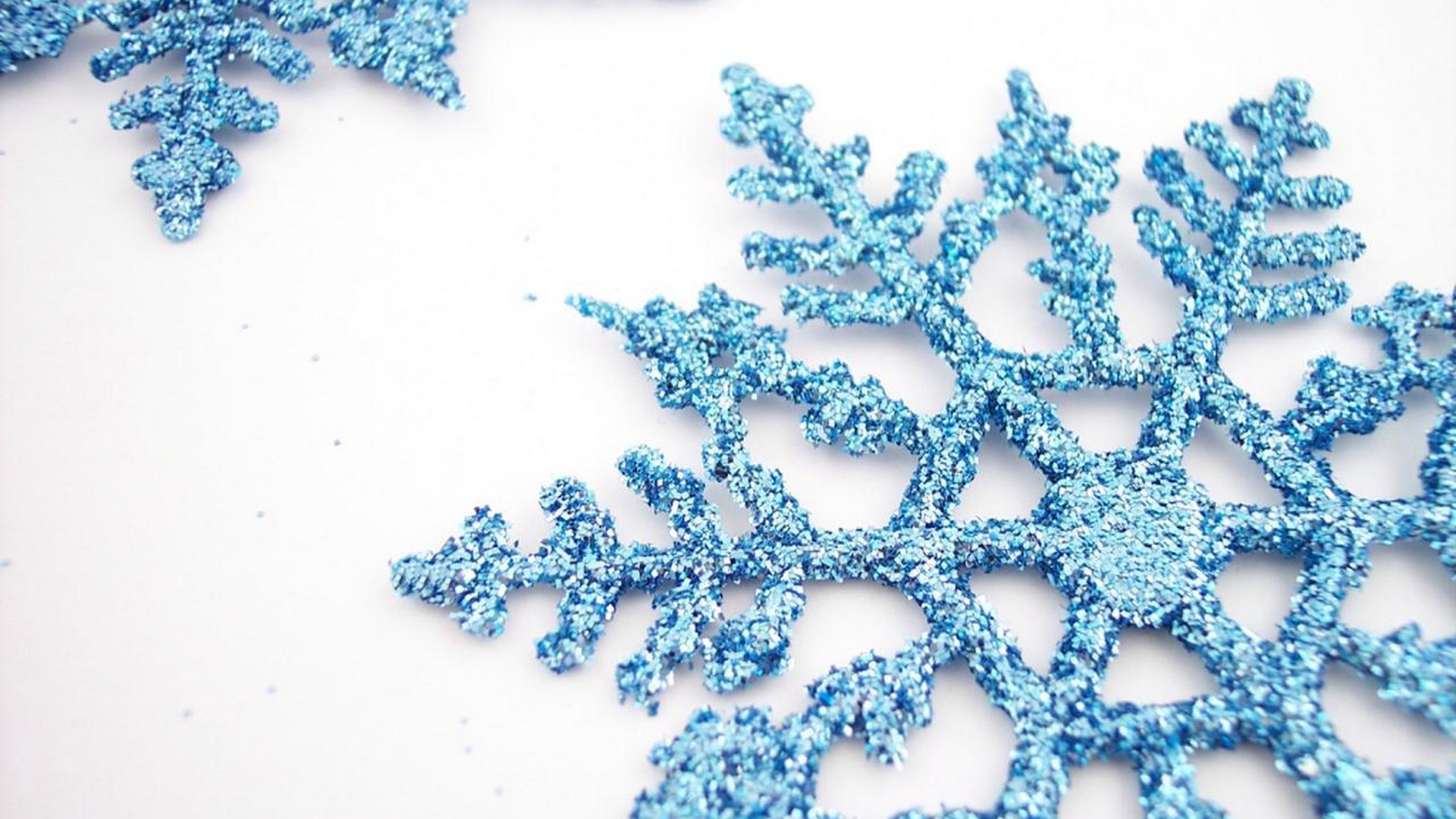 Blue snowflakes on a white table on Christmas
