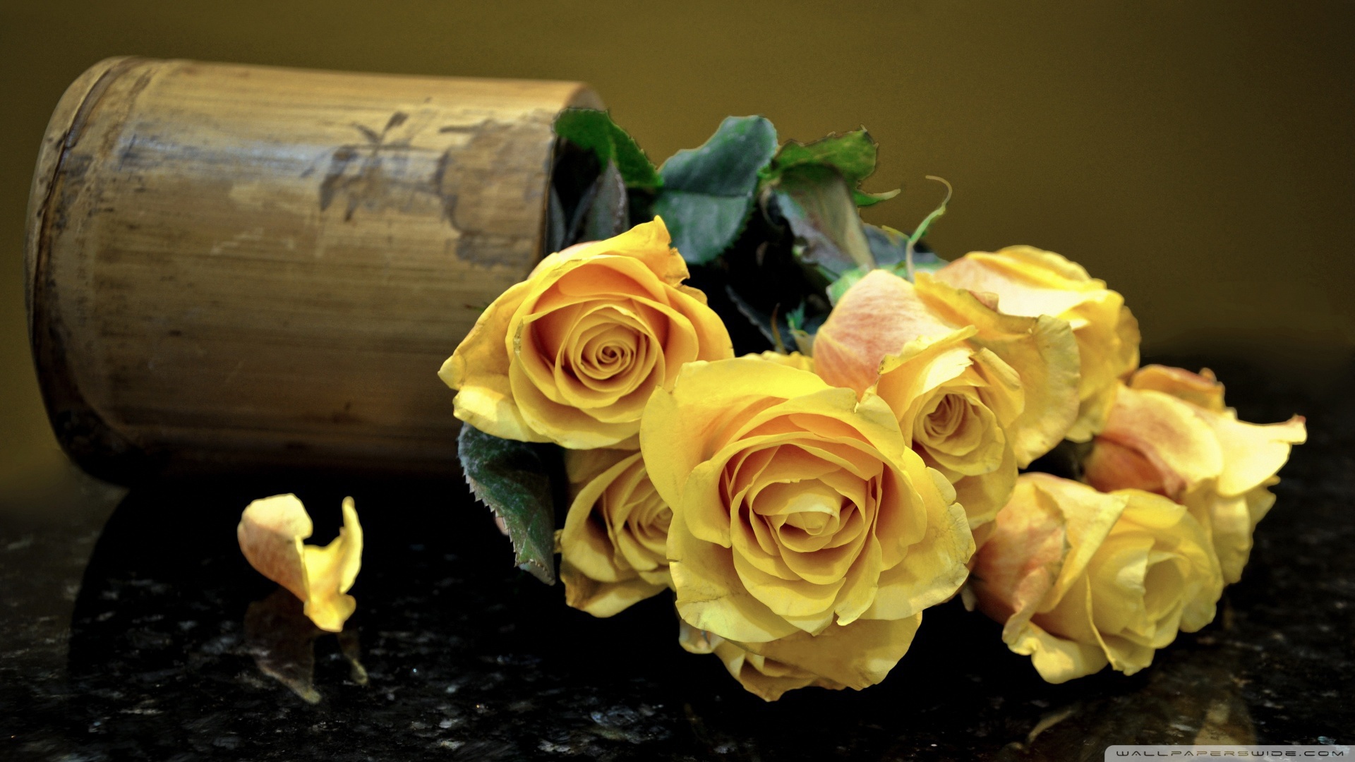 Yellow roses on a dark table