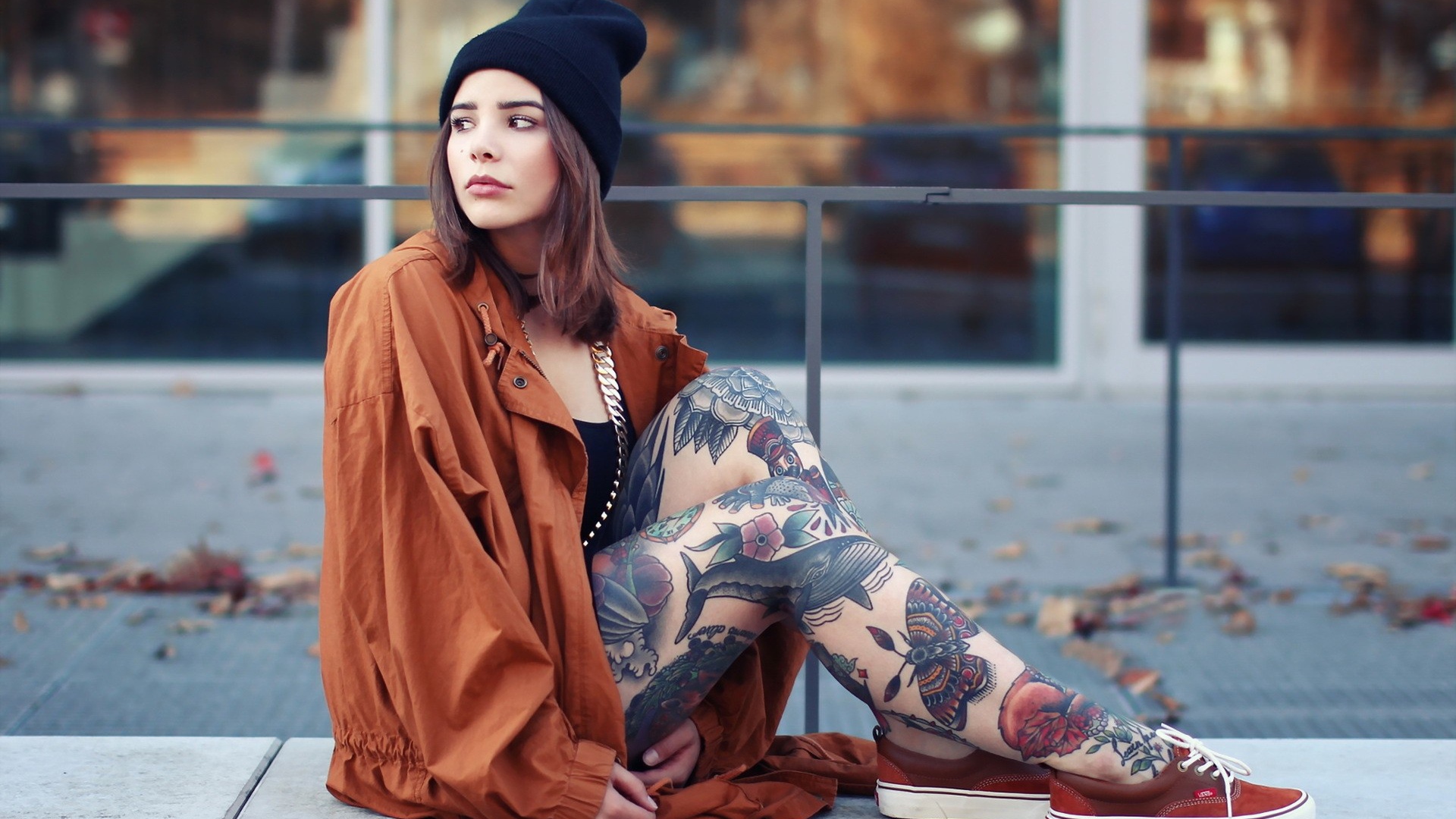 Девушка в шапке с тату на ногах
