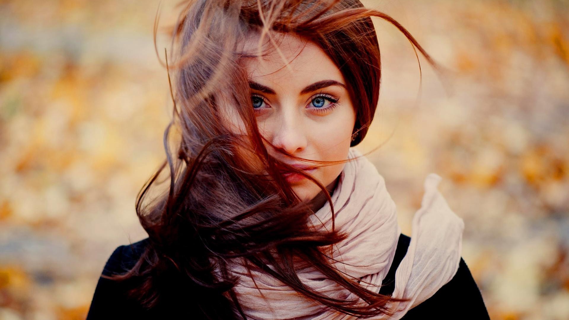 Ветер треплет волосы у девушки