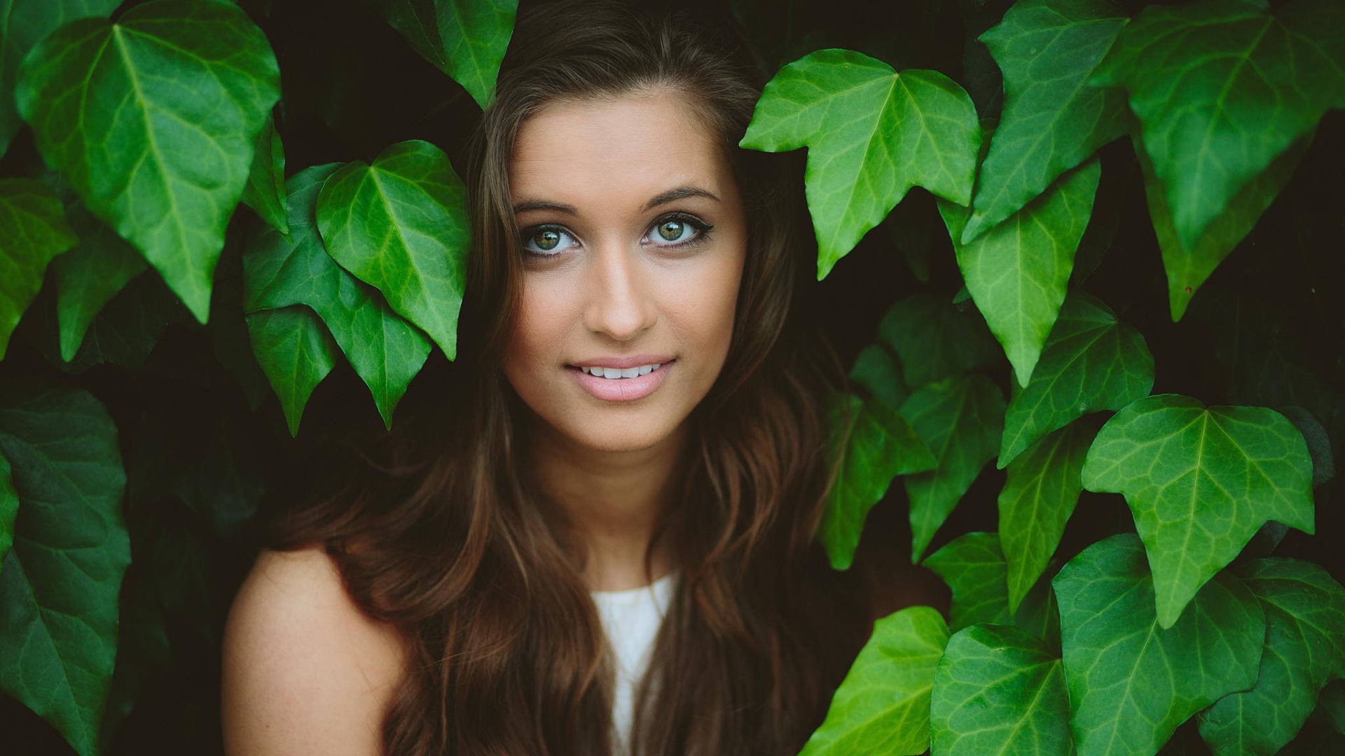 Зеленоглазая девушка модель среди листьев