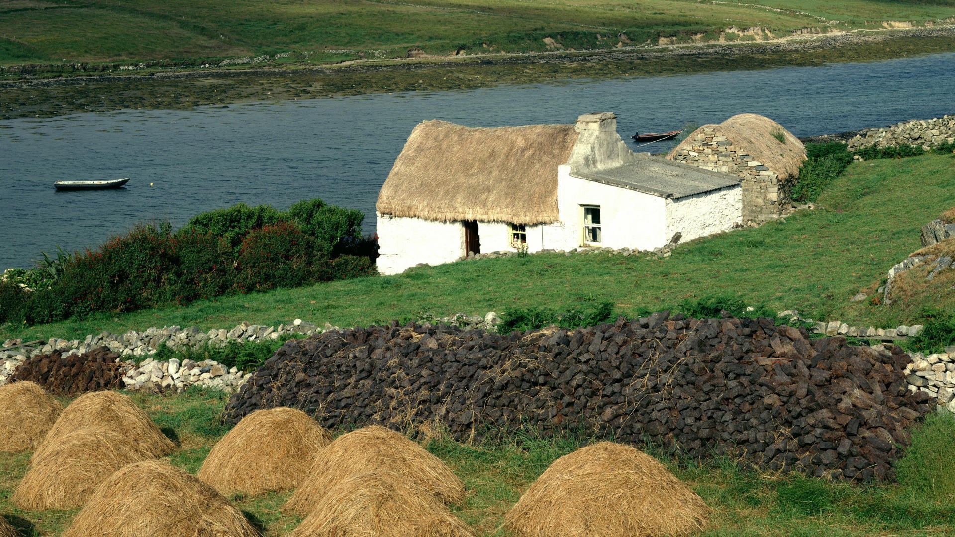 Покрытый соломой дом на берегу реки