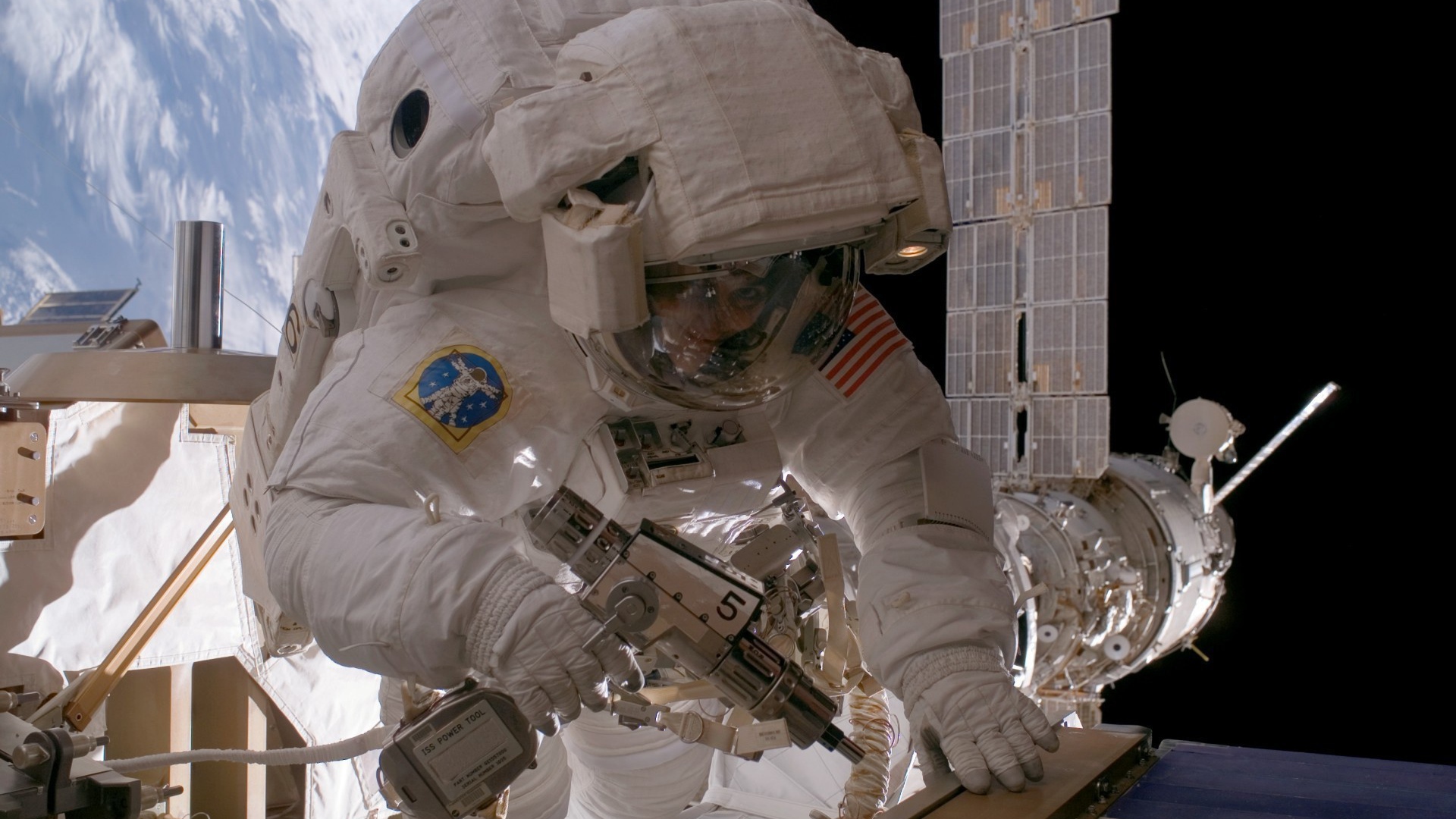 Космонавт на орбите выполняет ремонт