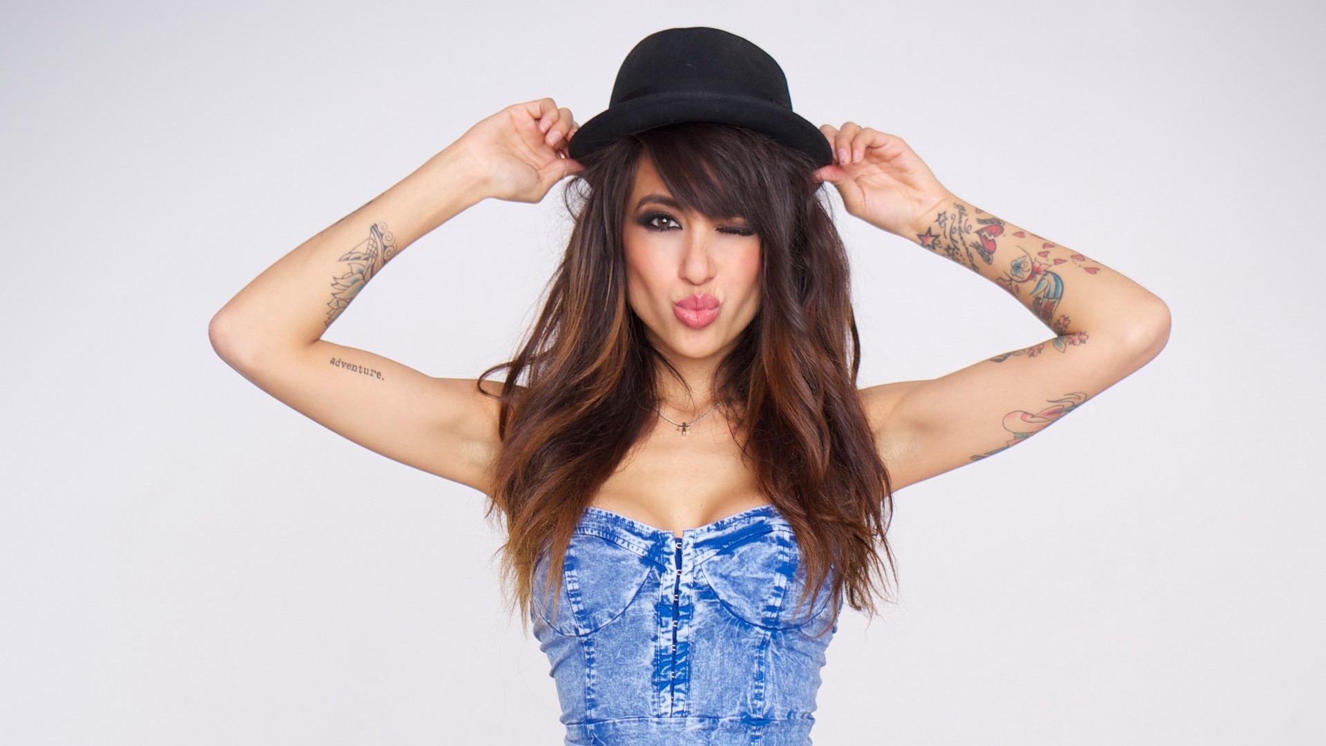 Girl in a black hat with a tattoo on hand