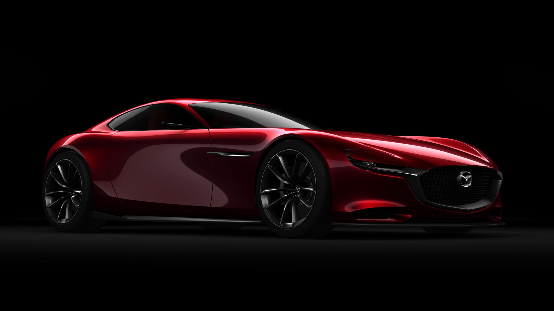 Красный спортивный автомобиль Mazda RX Vision Concept на черном фоне