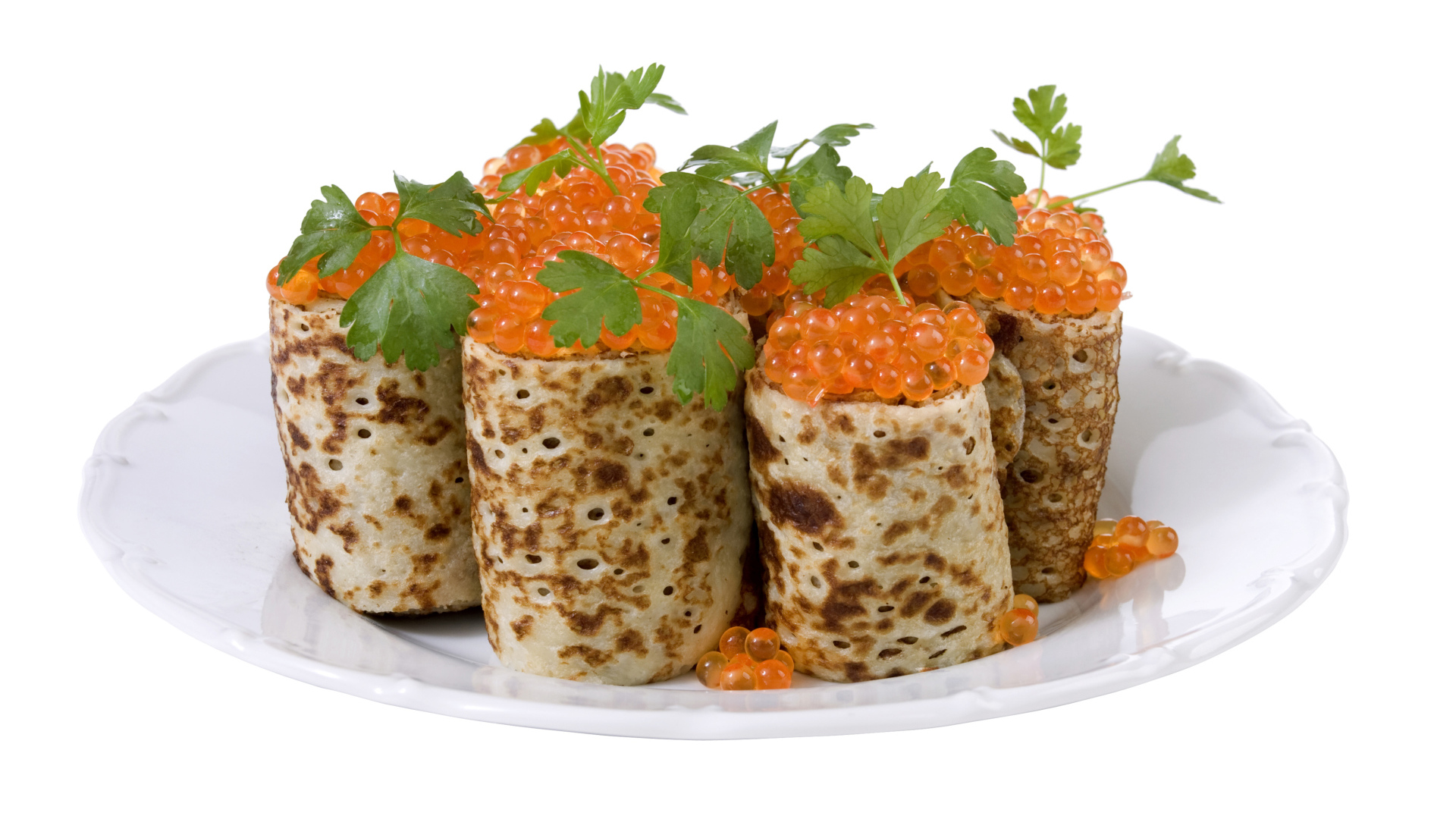 Роллы из блинов с красной икрой на белом блюде