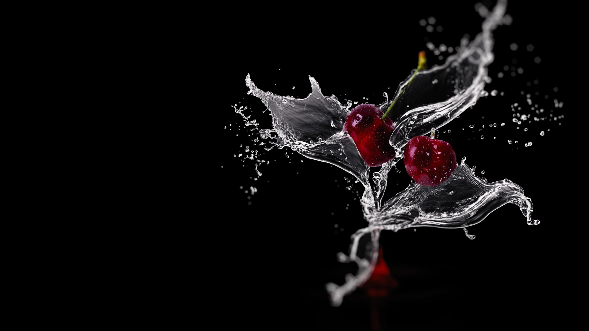 Две вишни в брызгах воды на черном фоне