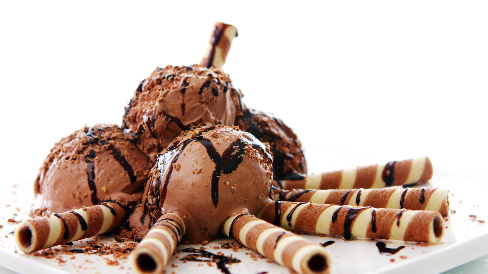 Chocolate ice cream with straws on white background