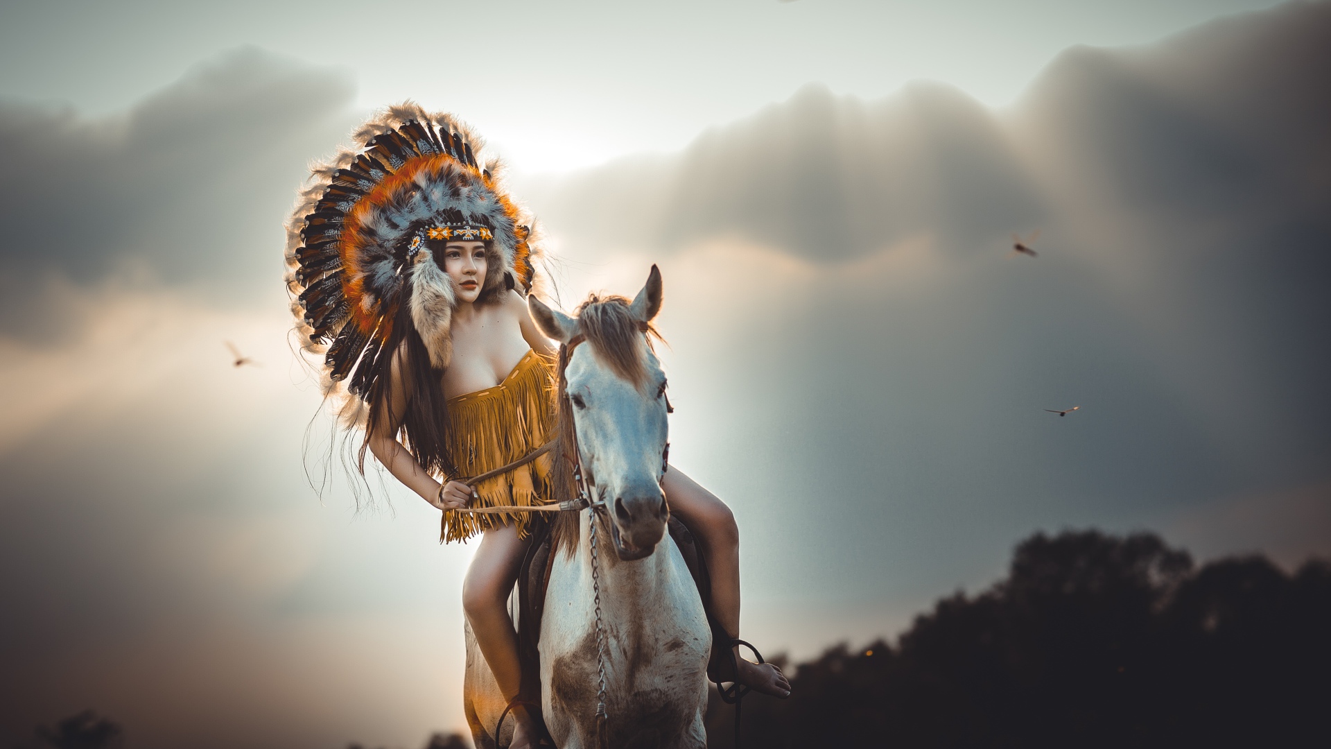 Молодая девушка в костюме индейца на коне
