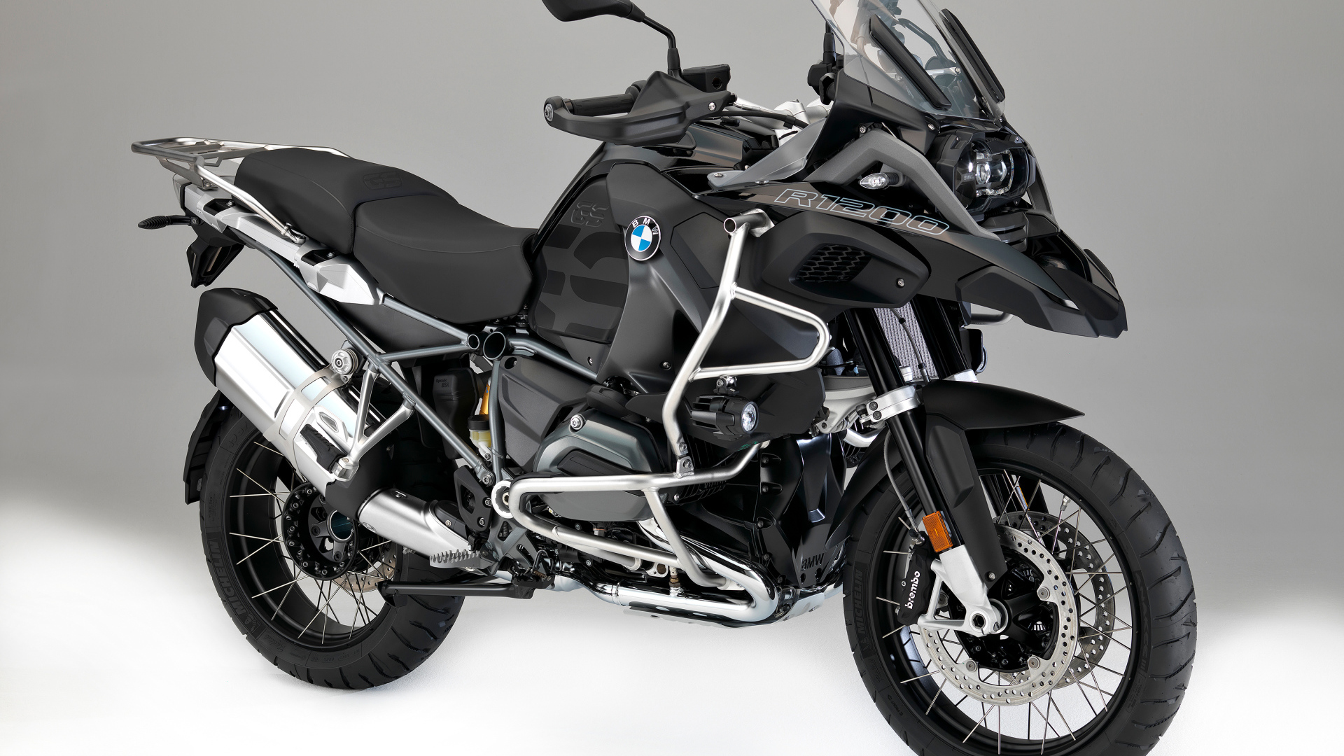 Черный мотоцикл BMW R1200GS на сером фоне