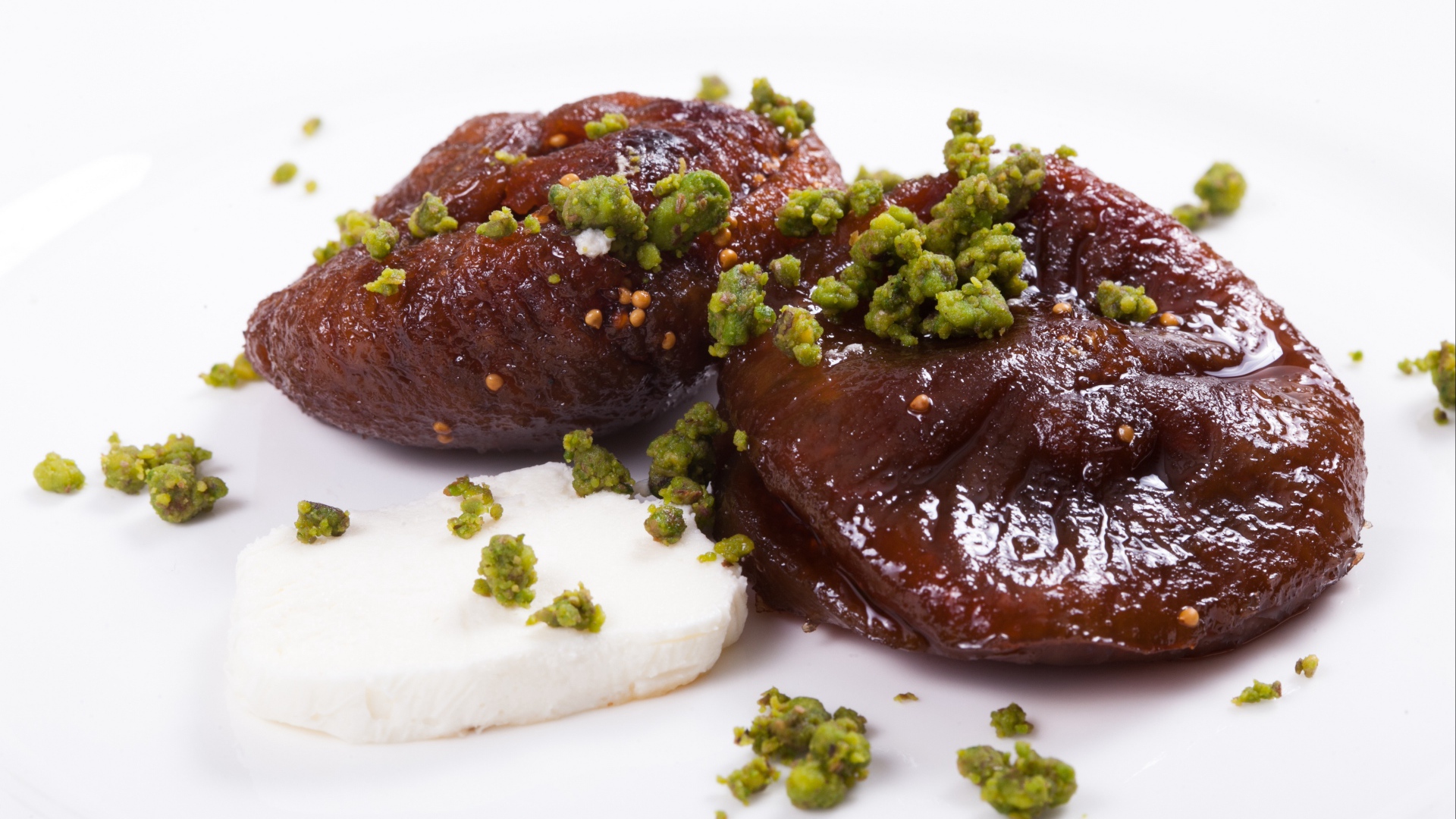 Инжир с фисташковыми орехами на белом фоне