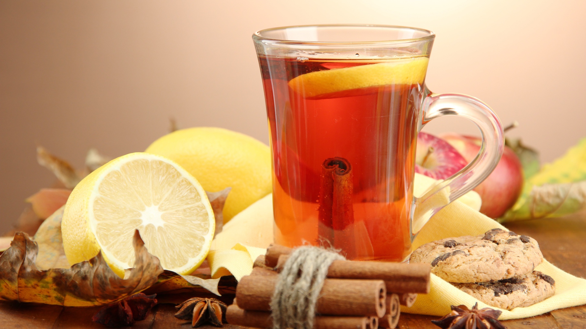 Чашка чая с лимоном и корицей на столе с лимонами