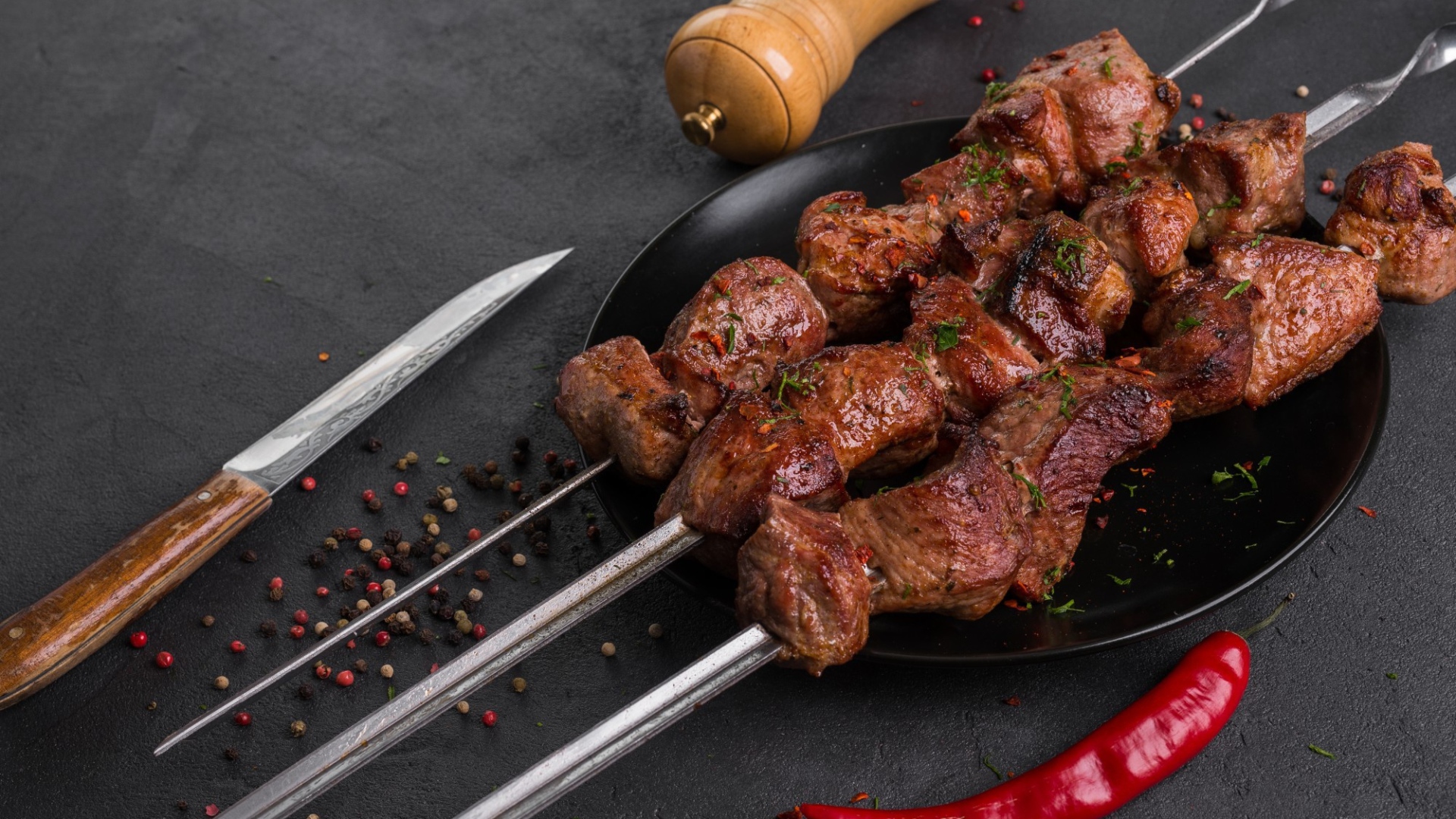 Appetizing meat shish kebab on a table with pepper