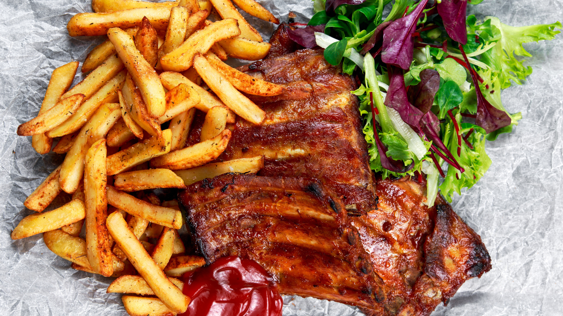 Жареные ребрышки с картофелем фри и салатом 