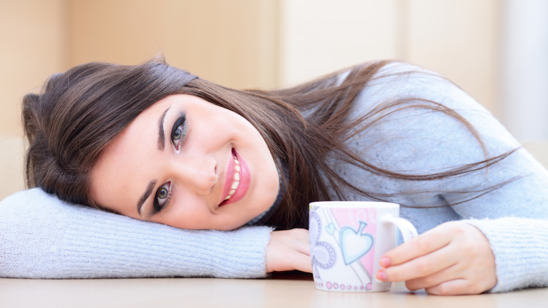 Нежная улыбающаяся девушка с чашкой